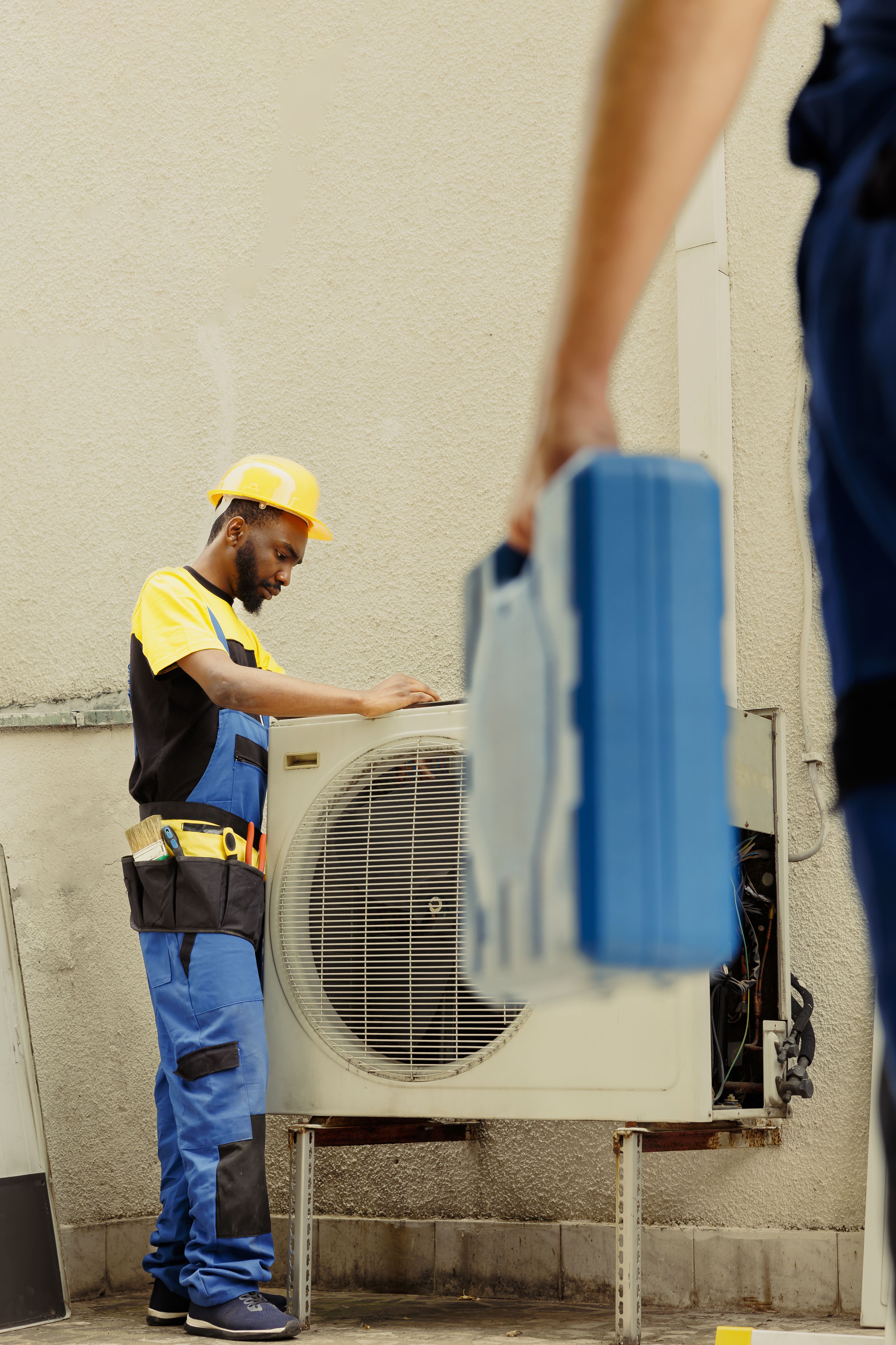 Air conditioning repair technician at work